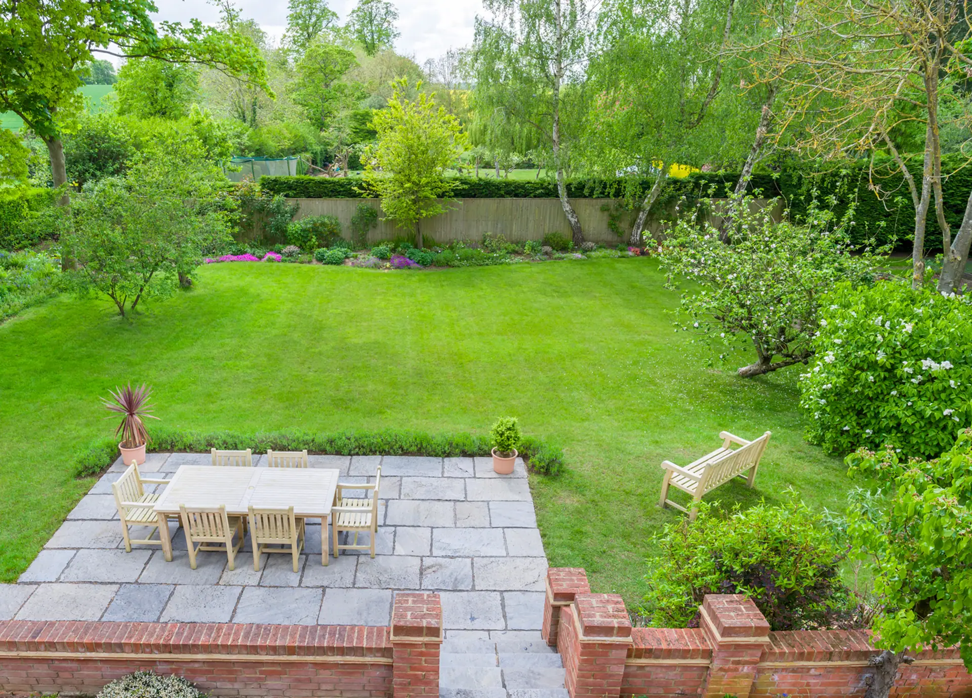 Spacious family garden with lawn and surrounding planting, Surrey.