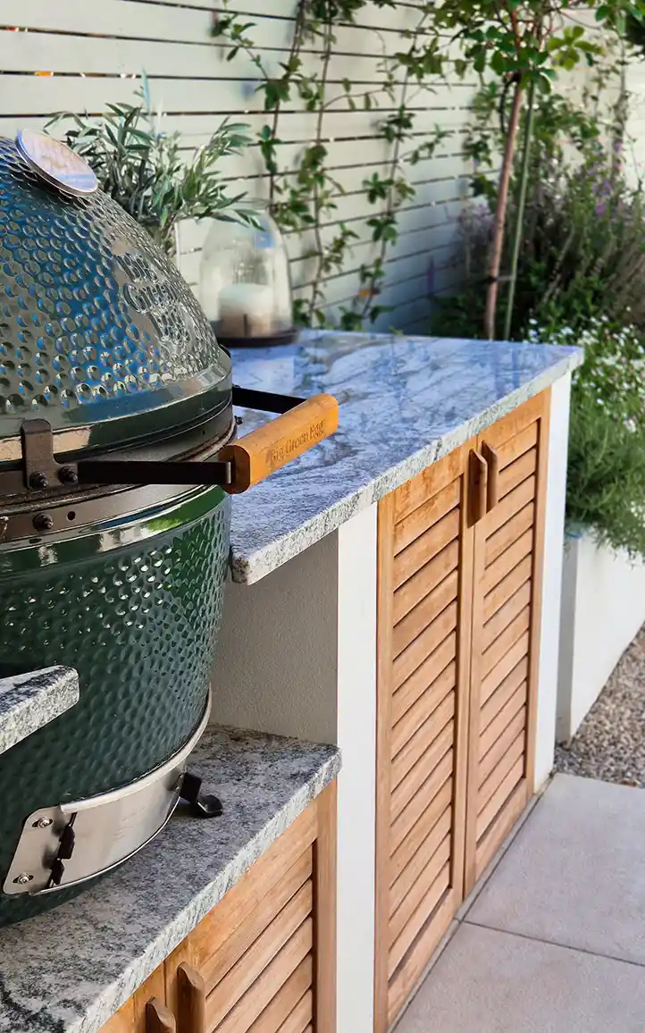 Bespoke outdoor kitchen with granite worktop and Big Green Egg in Surrey garden